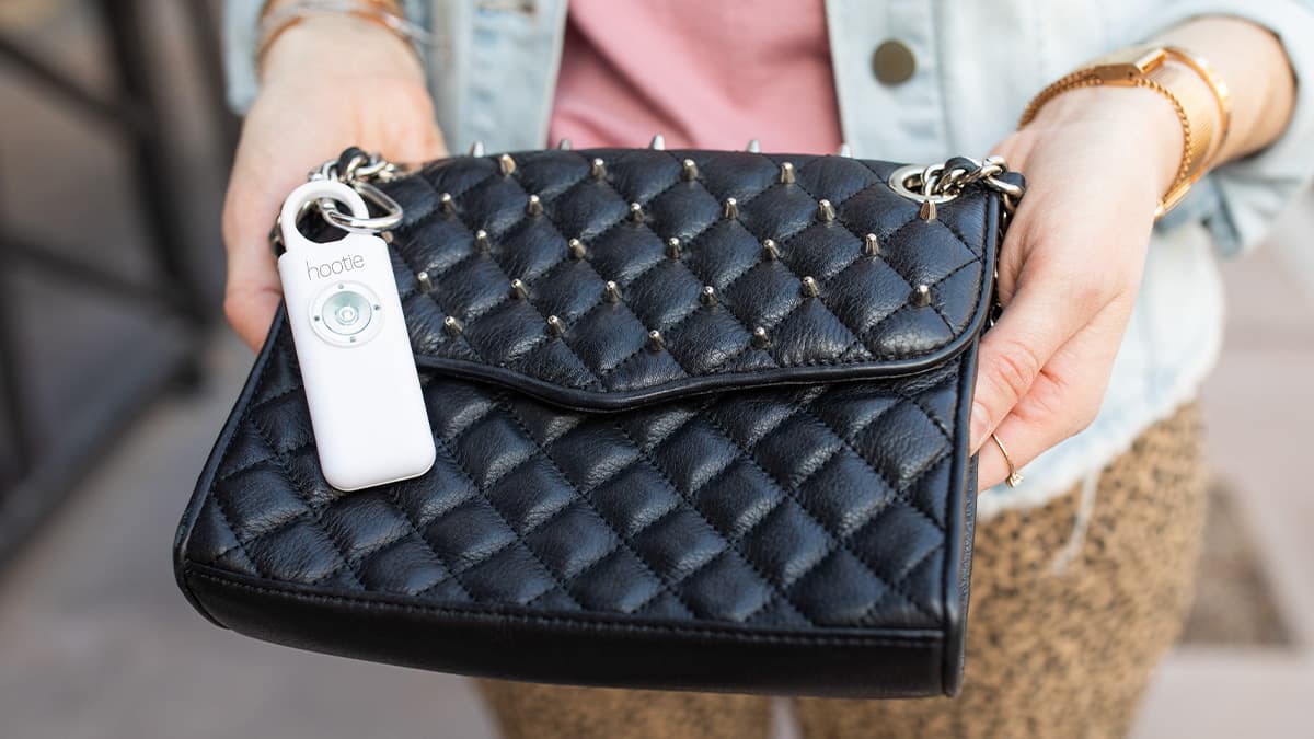 Hootie personal safety alarm attached to a bag